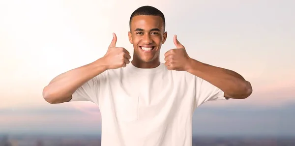 Young African American Man Giving Thumbs Gesture Smiling Because Has — Stock Photo, Image