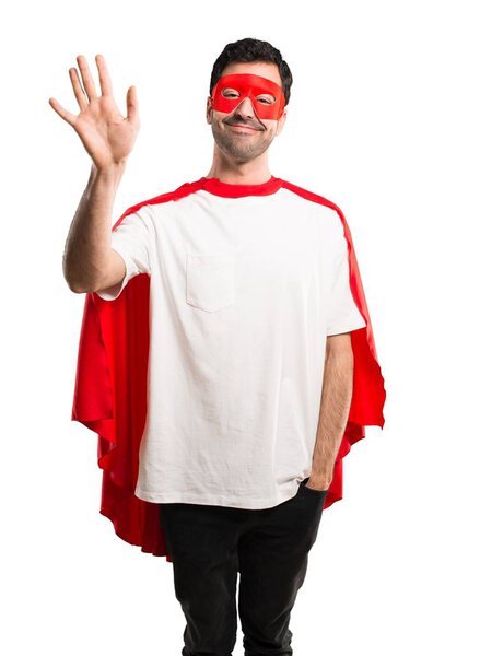 Superhero man with mask and red cape saluting with hand with happy expression on isolated white background