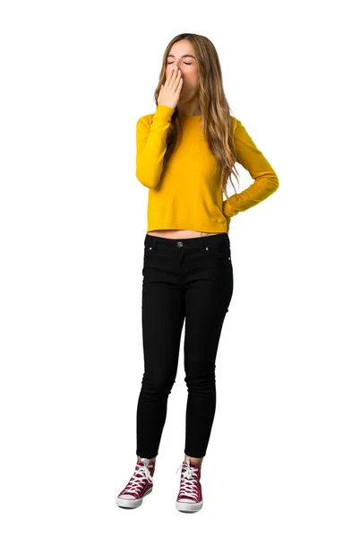 一个年轻女孩的全长镜头 她穿着黄色毛衣打哈欠 用手在孤立的白色背景上张开嘴 — 图库照片
