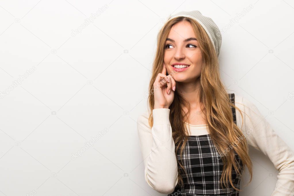 Fashionably woman wearing hat thinking an idea while looking up