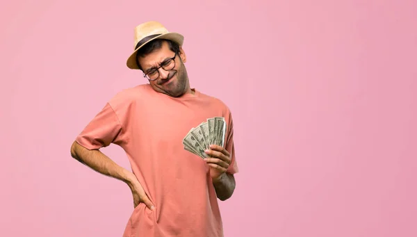 Man Holding Many Bills Suffering Backache Having Made Effort Pink — Stock Photo, Image