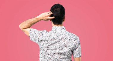 Yakışıklı adamla arkada pembe bir arka plan üzerinde pozisyon gözlük