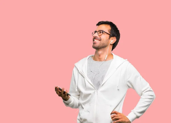 Man Glasses Listening Music Posing Arms Hip Laughing Pink Background — Stock Photo, Image