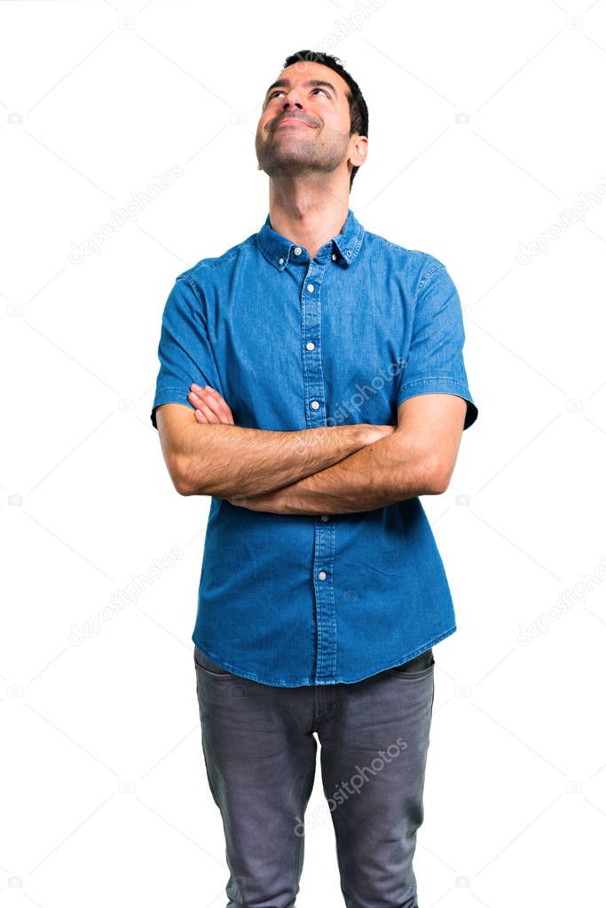 Handsome man with blue shirt stand and looking up