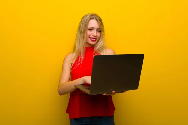 Young Girl Red Dress Yellow Wall Laptop — Stock Photo, Image