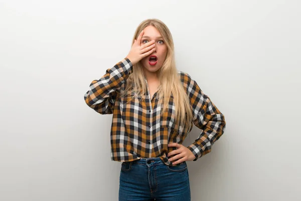 Jovem Loira Sobre Parede Branca Com Expressão Facial Surpresa Chocada — Fotografia de Stock