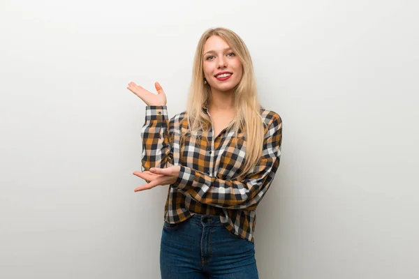 Blondes Junges Mädchen Über Weiße Wand Die Hände Zur Seite — Stockfoto