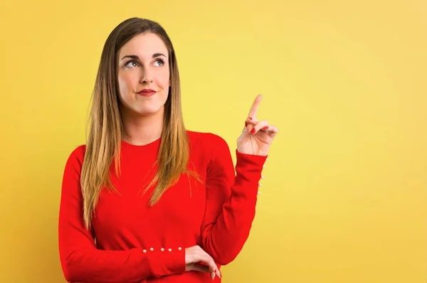 Young Blonde Woman Pointing Index Finger Great Idea Yellow Background — Stock Photo, Image
