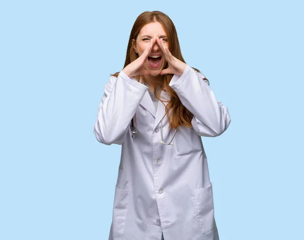 Rossa Medico Donna Gridando Annunciando Qualcosa Sfondo Blu Isolato — Foto Stock