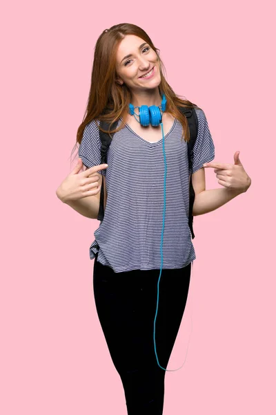 Redhead student woman proud and self-satisfied in love yourself concept on isolated pink background