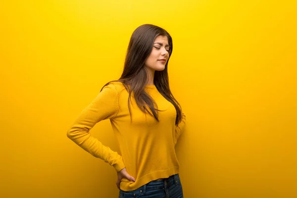 Teenager Girl Vibrant Yellow Background Suffering Backache Having Made Effort — Stock Photo, Image
