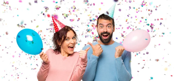 Couple Balloons Birthday Hats Giving Thumbs Gesture Smiling Because Has — Stock Photo, Image