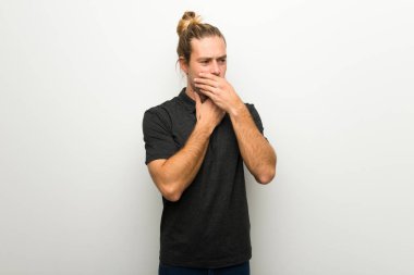 Beyaz duvar üzerinde uzun saçlı sarışın adam öksürük ile acı ve kötü hissediyor