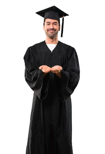 男子在他的毕业日大学举行模仿空间想象在手掌插入广告在孤立的白色背景 — 图库照片