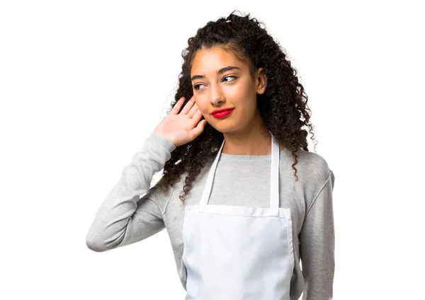 Young Girl Apron Listening Something Putting Hand Earon White Background — Stock Fotó