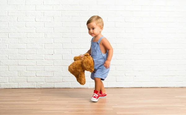 Adorable Bebé Con Peluche Sobre Fondo Ladrillo Blanco —  Fotos de Stock