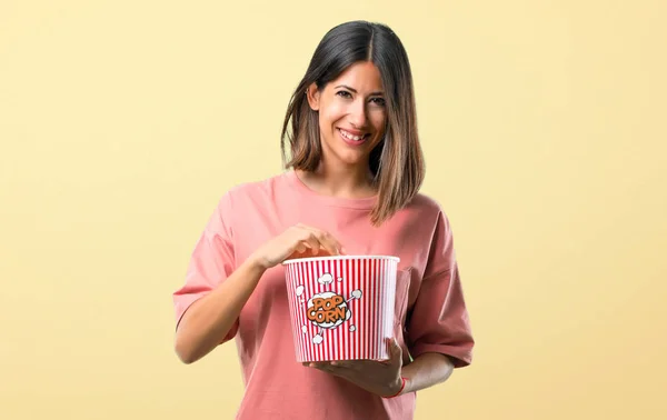 Happy Young Girl Pink Shirt Eating Popcorns Yellow Background — Stock Photo, Image