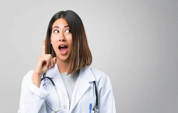 Mujer Doctora Con Estetoscopio Pie Pensando Una Idea Apuntando Con —  Fotos de Stock