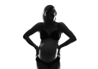 Sanatsal izole arka plan üzerinde sarışın hamile kadın silüeti