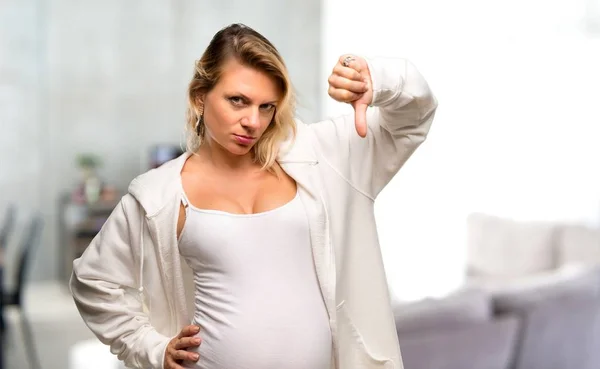 Pregnant Blonde Woman White Sweatshirt Showing Thumb Sign Negative Expression — ストック写真