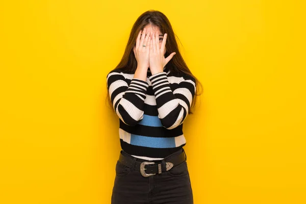 Young Woman Yellow Wall Covering Eyes Hands Looking Fingers — Stock Fotó