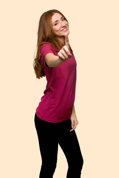 Young Redhead Girl Showing Lifting Finger Isolated Yellow Background — Stock Photo, Image