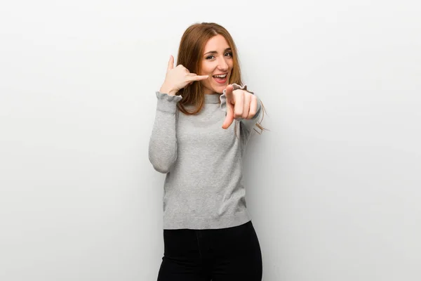 Redhead Girl White Wall Making Phone Gesture Pointing Front — Stockfoto