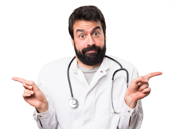 Young Doctor Pointing Laterals Having Doubts White Background — Stock Photo, Image