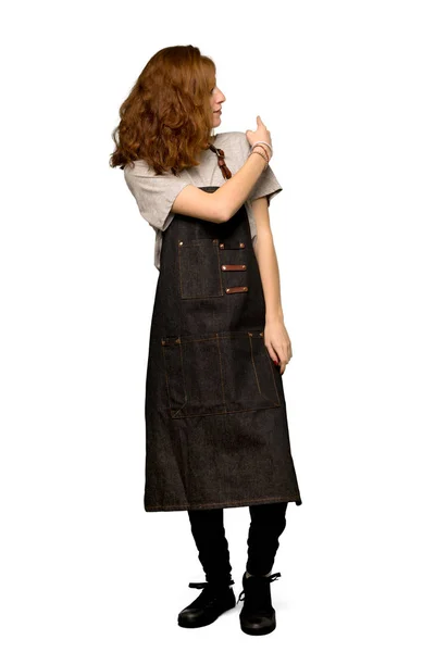 Full Length Shot Young Redhead Woman Apron Pointing Back Index — Stock Photo, Image