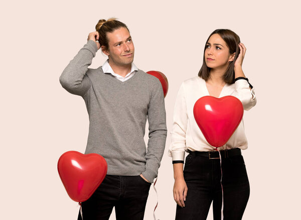 Couple in valentine day having doubts while scratching head over isolated background