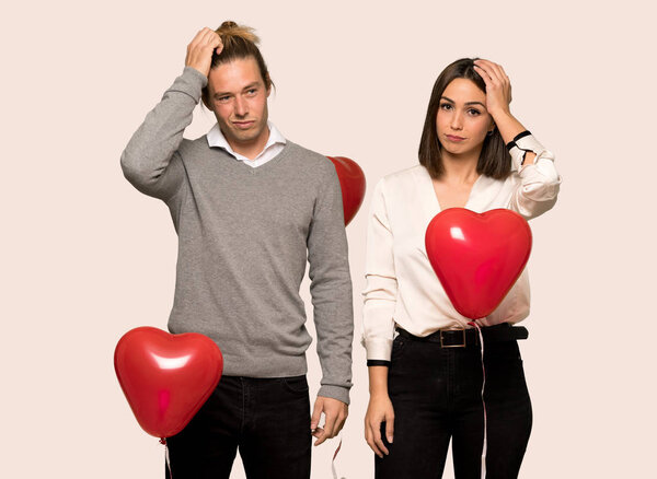 Couple in valentine day with an expression of frustration and not understanding over isolated background