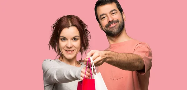 Couple Valentine Day Holding Lot Shopping Bags Isolated Pink Background — Stock Photo, Image