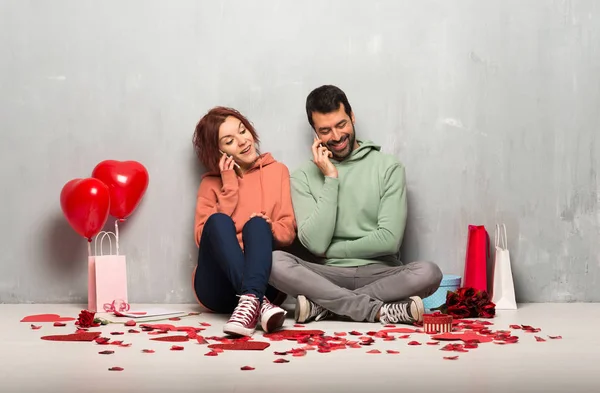 携帯電話で会話を維持するバレンタインの日のカップル — ストック写真