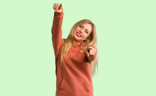 Young Girl Points Finger You While Smiling Green Background — Stock Photo, Image