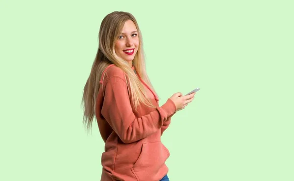 Young Girl Sending Message Mobile Green Background — Stock Photo, Image