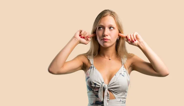 Young Blonde Woman Covering Both Ears Hands Ocher Background — Stock Photo, Image