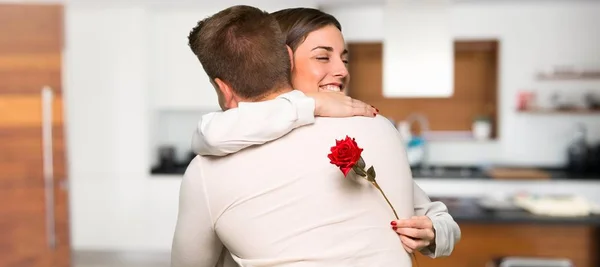 Couple in valentine day with flowers in a house