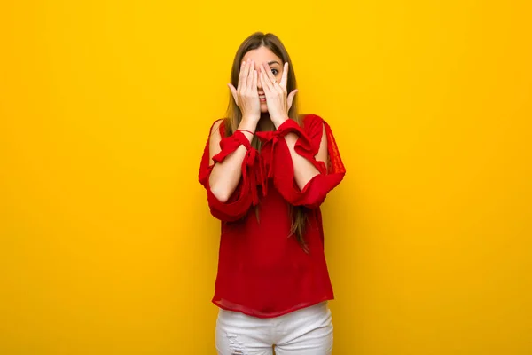 Young Girl Red Dress Yellow Wall Covering Eyes Hands Looking — Stock Photo, Image