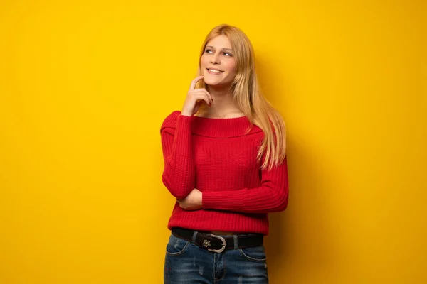 Blonde Frau Über Gelbe Wand Denkt Eine Idee Während Sie — Stockfoto