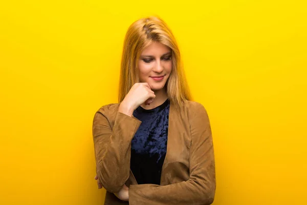 Blonde Girl Vibrant Yellow Background Looking Hand Chin — Stock Photo, Image
