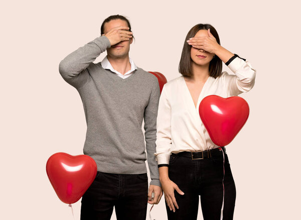Couple in valentine day covering eyes by hands. Do not want to see something over isolated background