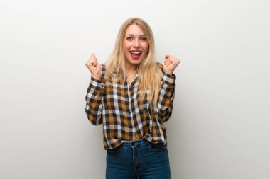 Sarışın genç kız üzerinde beyaz duvar kazanan konum bir zaferini kutluyor