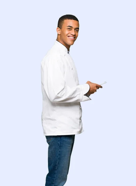 Young Afro American Chef Man Sending Message Mobile Isolated Background — Stock Photo, Image