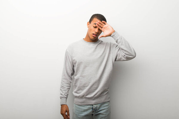 African american man on white wall background with tired and sick expression