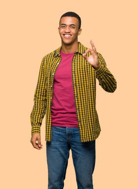 Genç afro Amerikalı adam bir ok işareti parmak ile izole arka plan üzerinde gösterilen