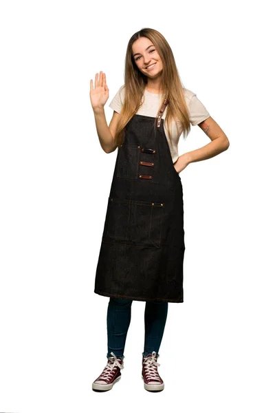 Full Body Young Woman Apron Saluting Hand Happy Expression Isolated — Stock Photo, Image
