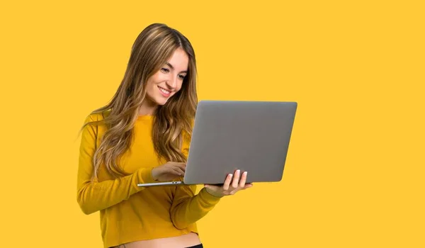 Young Girl Yellow Sweater Laptop Isolated Yellow Background — Stock Photo, Image