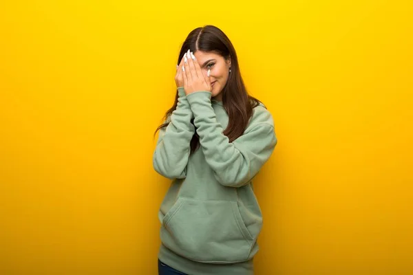 Teenager Girl Green Sweatshirt Yellow Background Covering Eyes Hands Looking — Stock Photo, Image