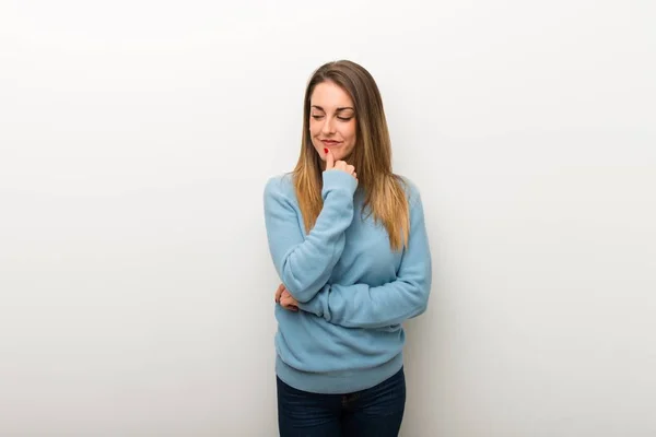 Blonde Woman Isolated White Background Looking Hand Chin — Stock Photo, Image