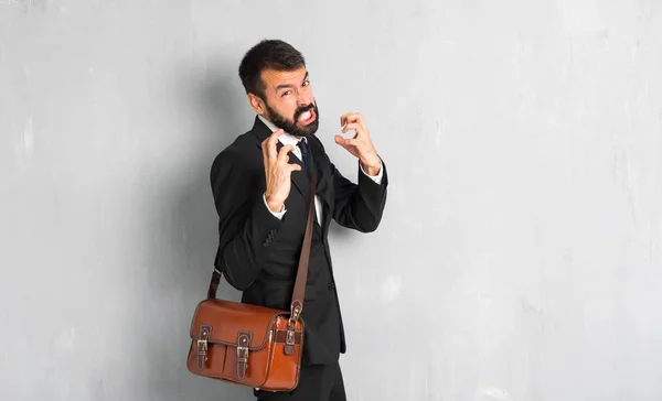 Businessman with beard annoyed angry in furious gesture